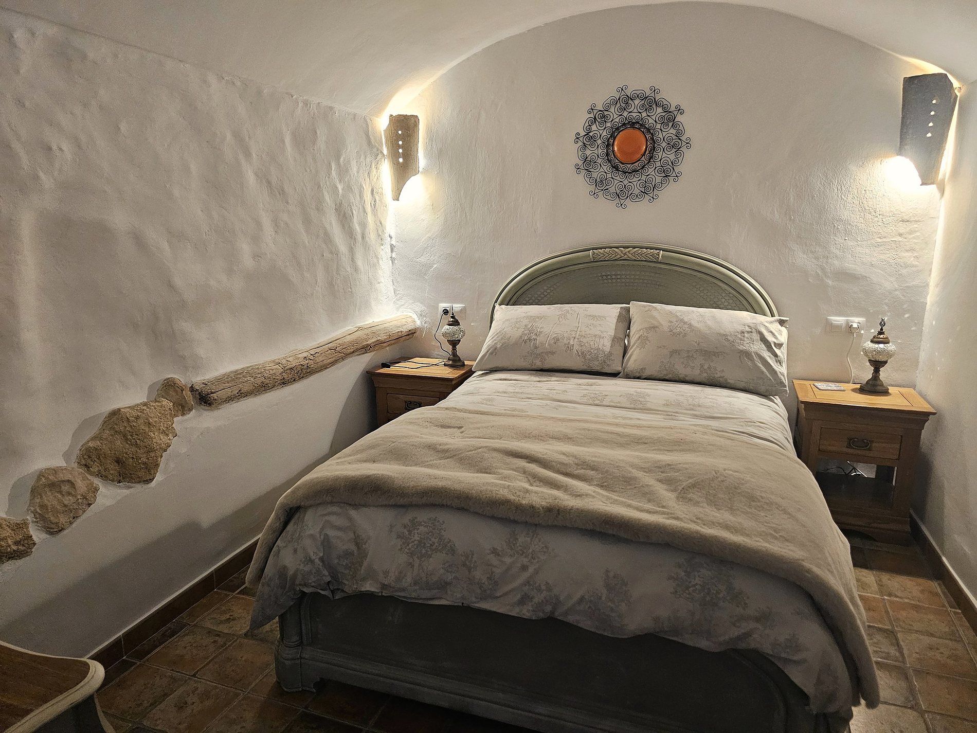 Double bedroom beneath curved white cave walls at Leonard’s Lookout