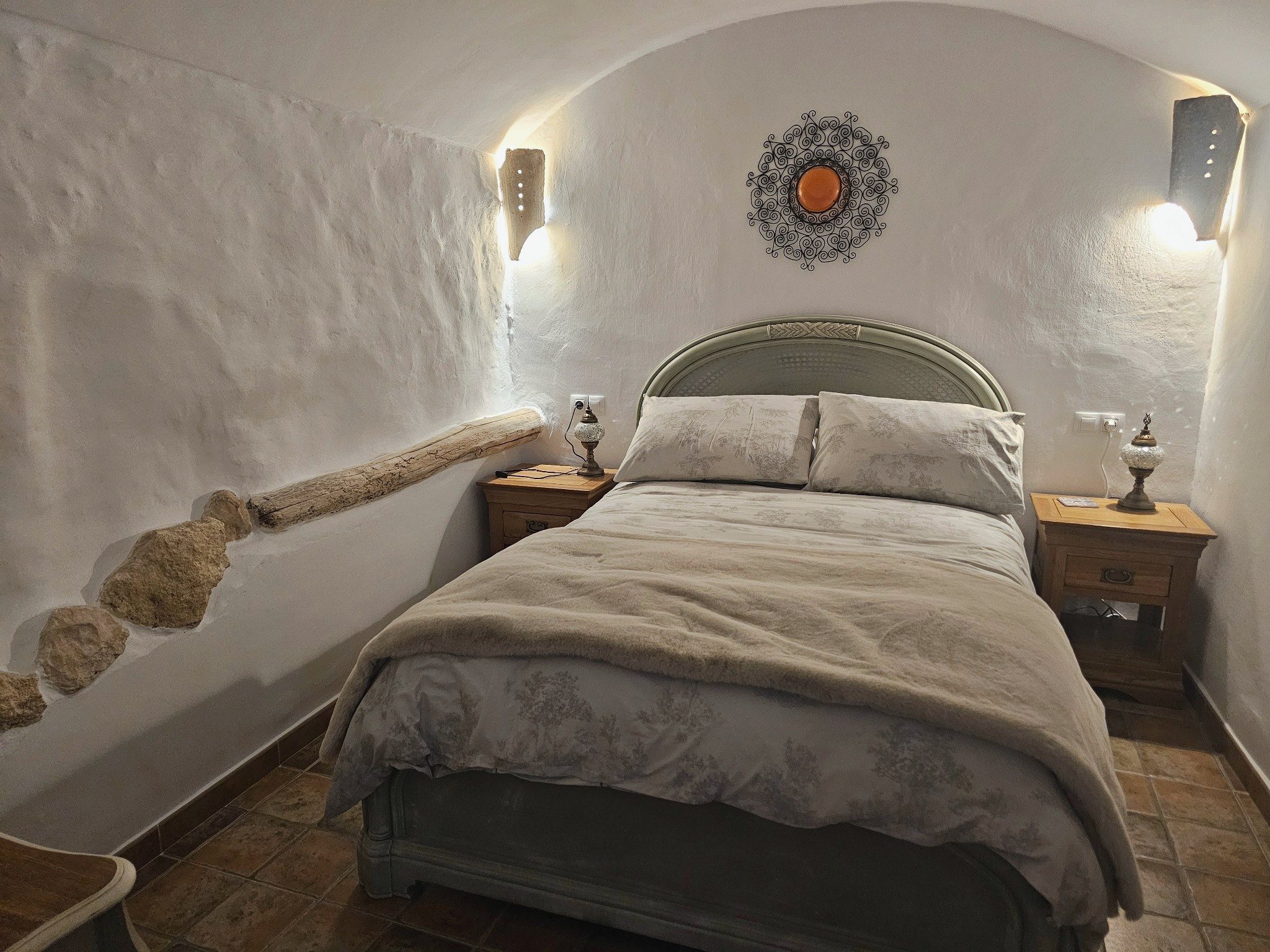 Double bedroom with curved white cave walls at Leonard’s Lookout