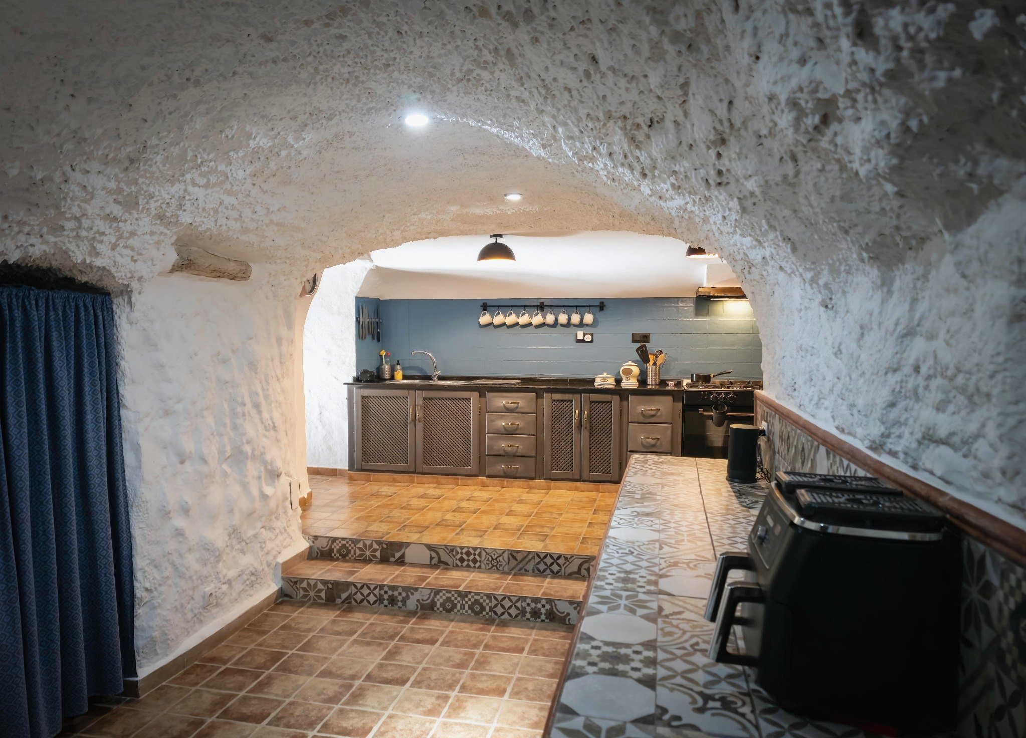 Whitewashed cave kitchen inside Leonard’s Lookout in rural Granada