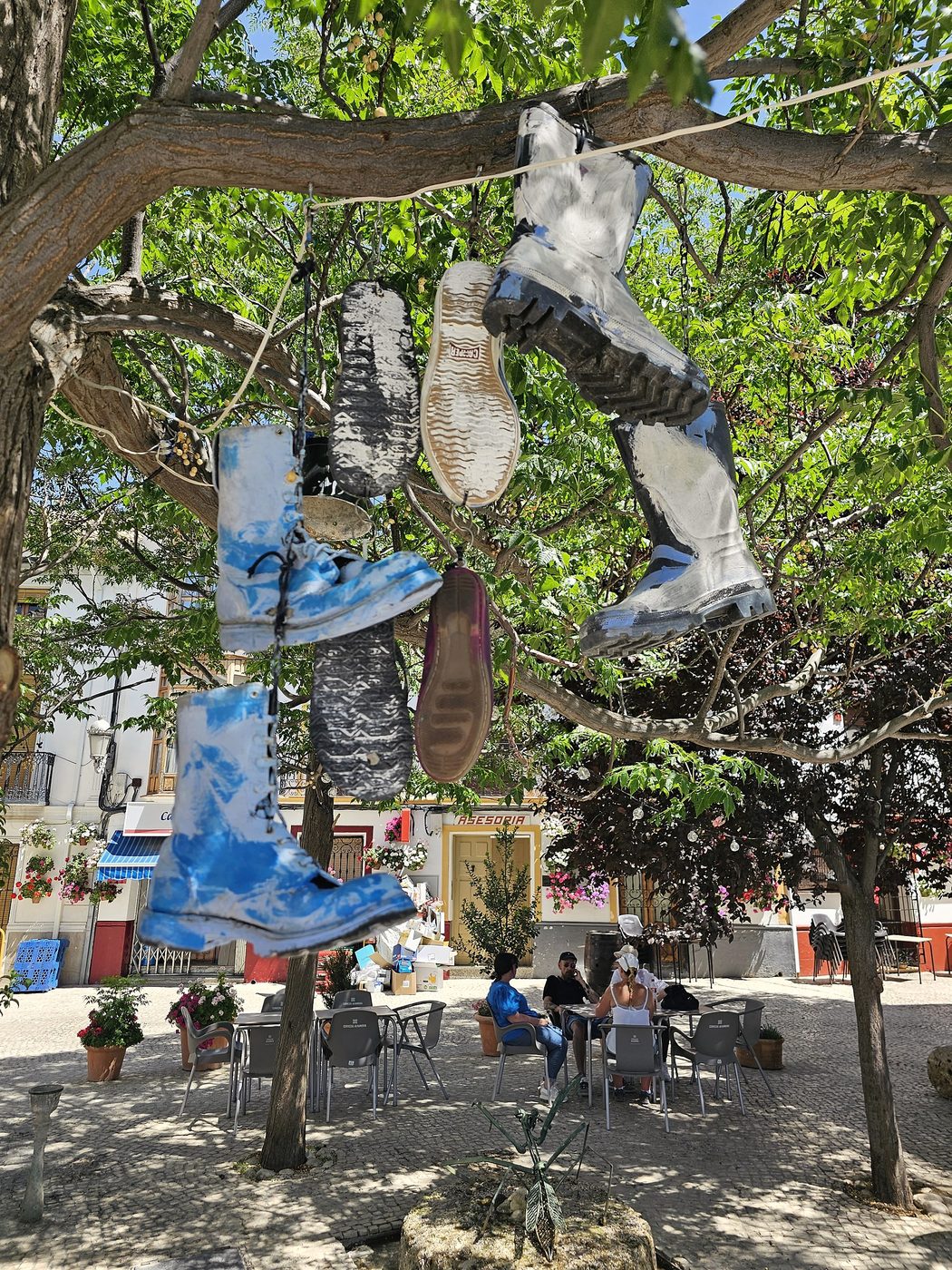 Shaded village square and outdoor café seating in Castril, Granada