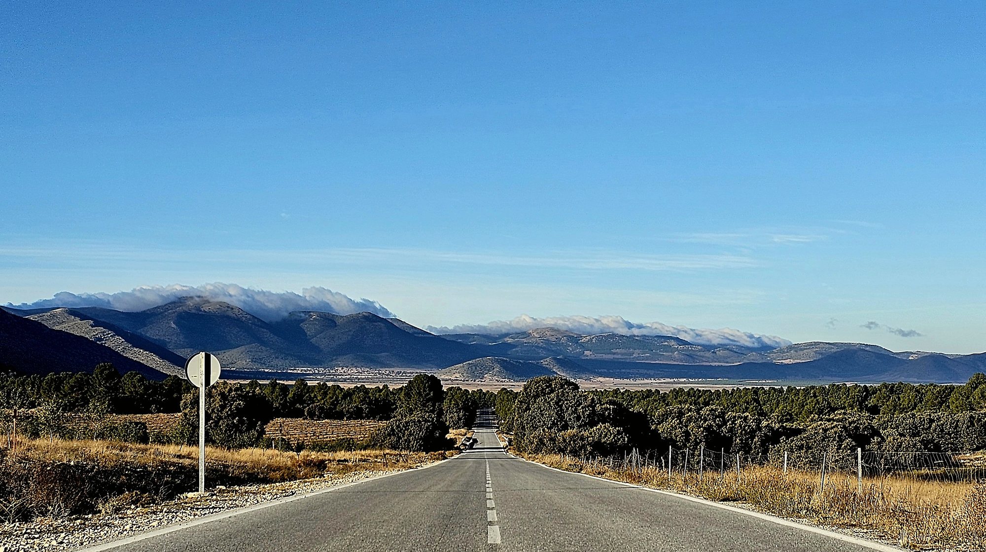 Quiet road through northern Granada towards the mountains