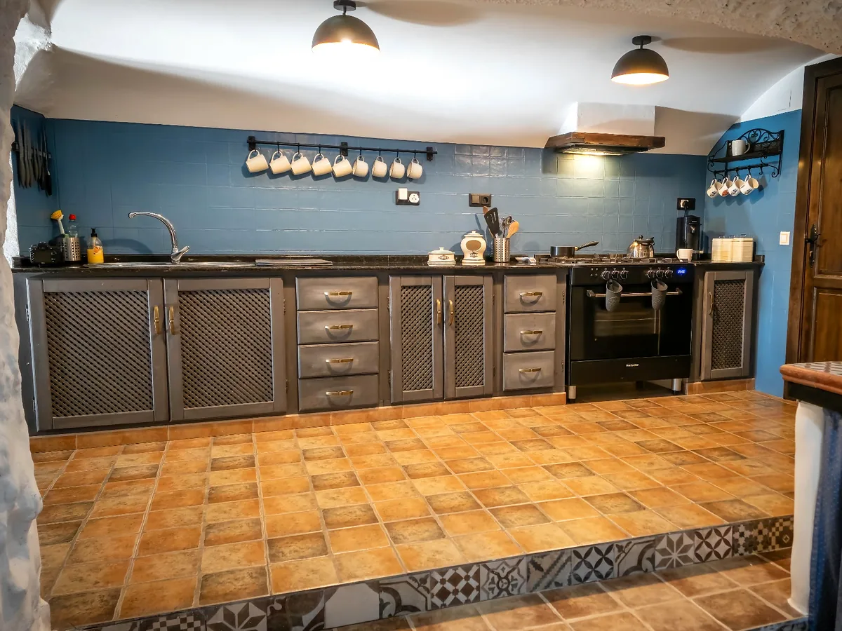 Cave-house kitchen with blue tiled wall at Leonard's Lookou