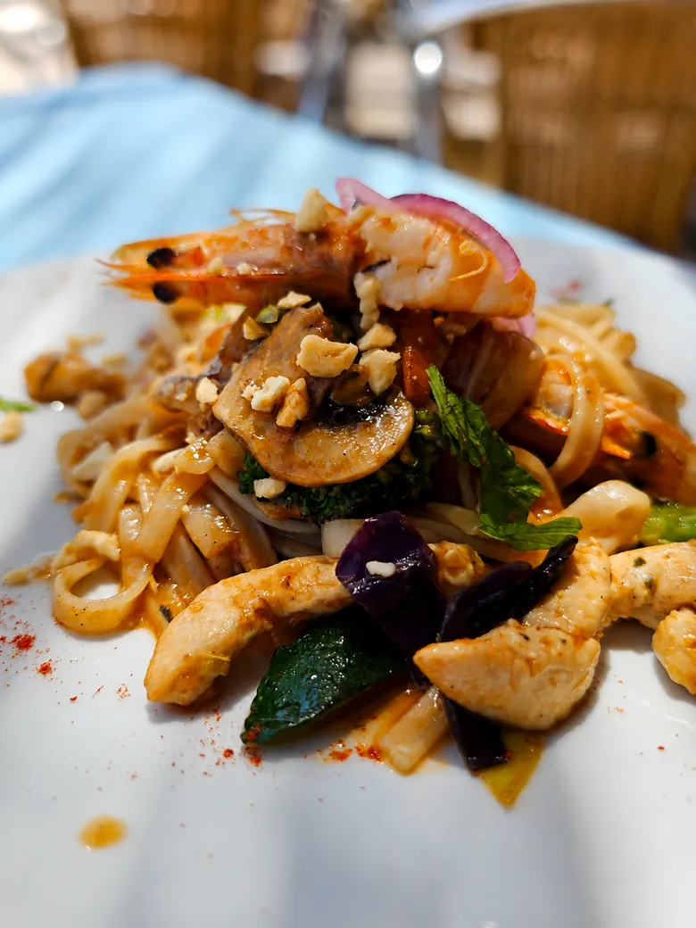 Seafood pasta with prawns, vegetables and herbs served in rural Granada