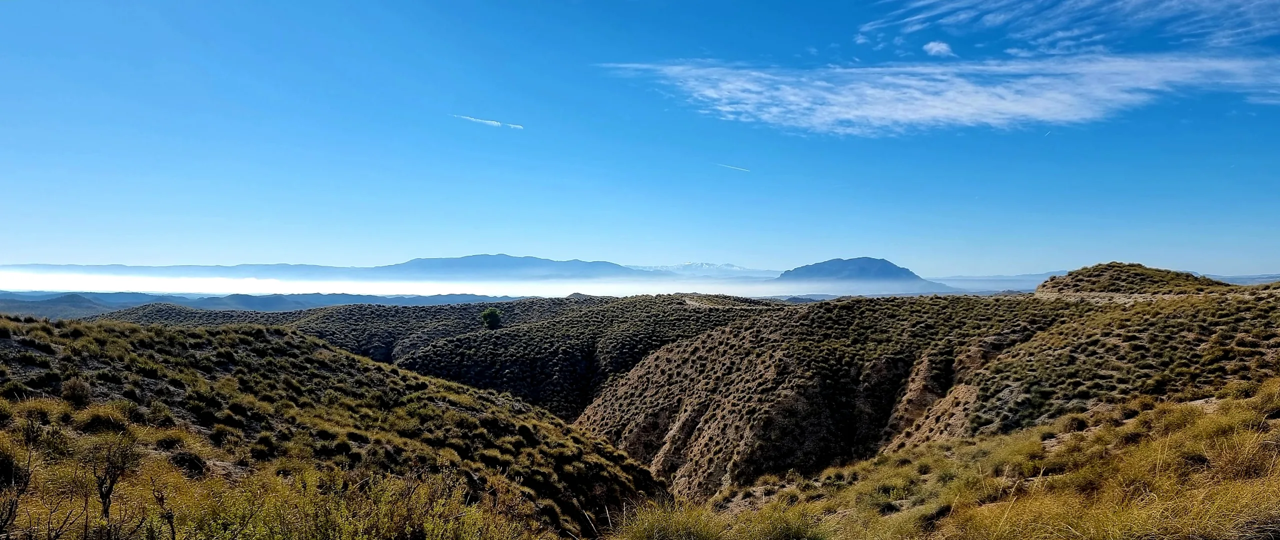Rural Granada landscape with rolling hills and distant mountains near Leonard's Lookout